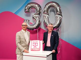 Tim Höttges and Christian Illek with cake and balloons for the 30th company aniversery.